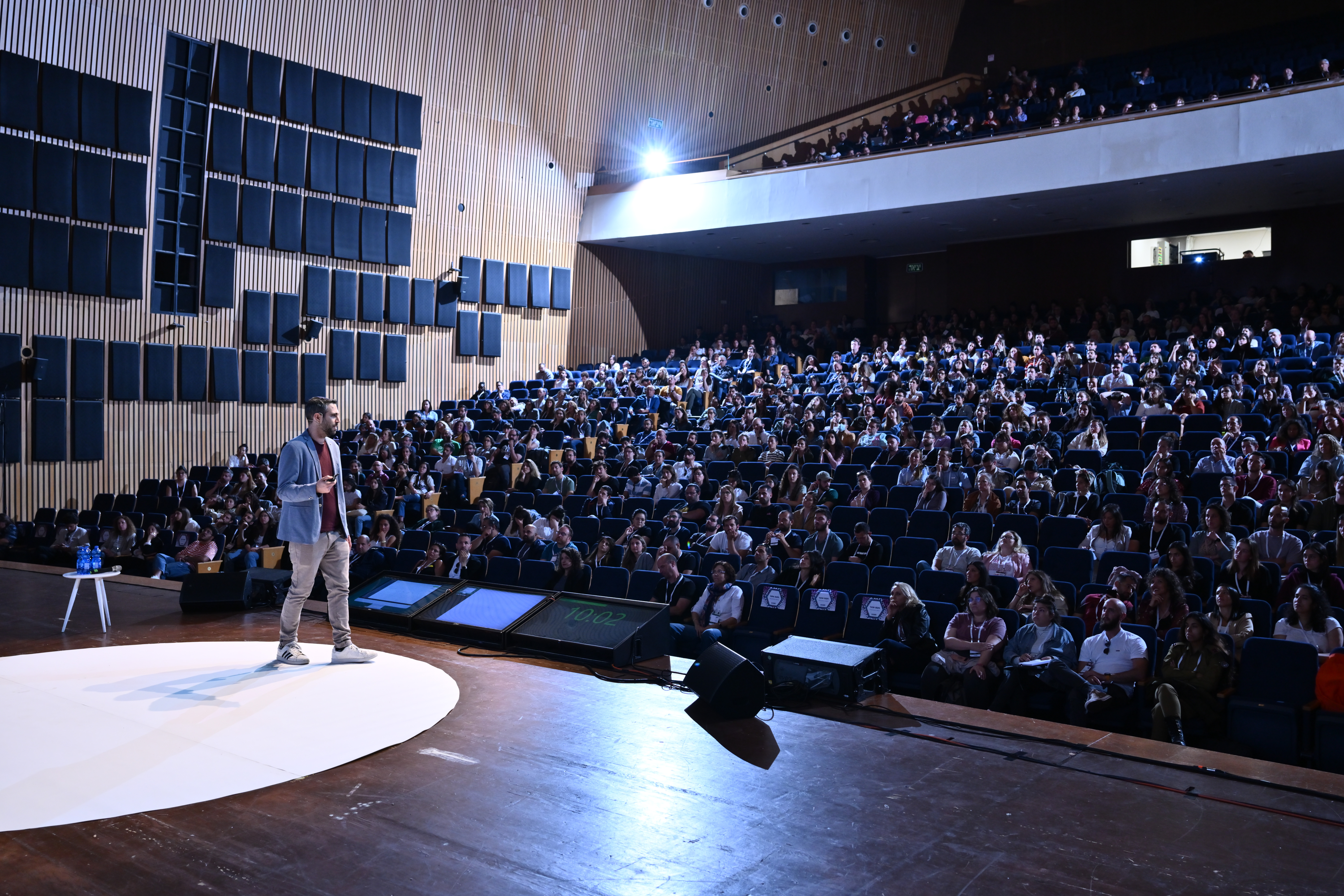 David Balsam speaking at a large conference hall