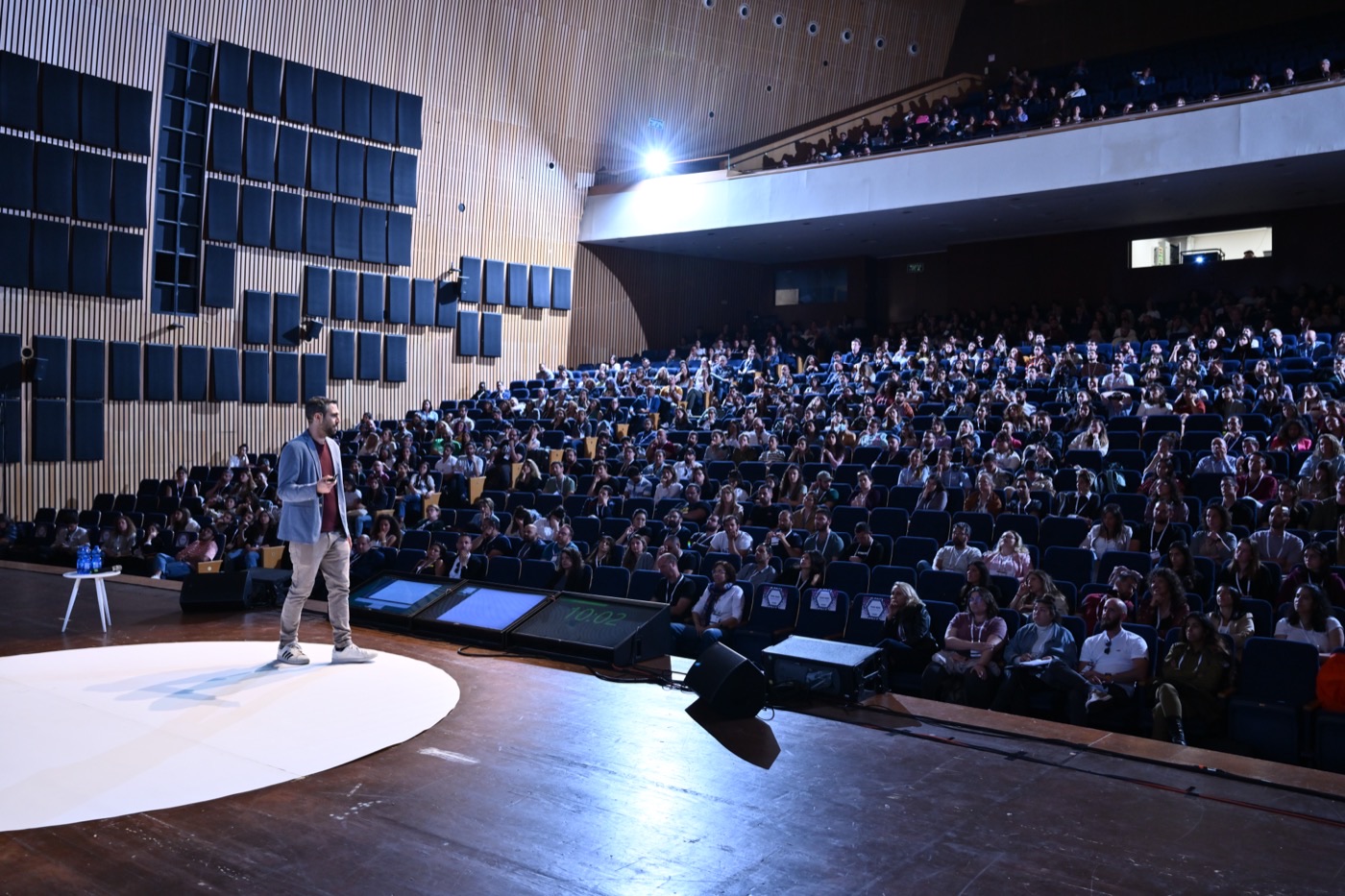 David Balsam speaking at a large conference hall